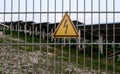 High voltage warning sign at fence of solar field