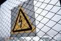 High voltage warning sign on wire mesh. High Voltage Danger Sign Royalty Free Stock Photo