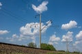 High-voltage wire along railway under blue sky Royalty Free Stock Photo