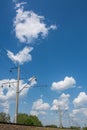 High-voltage wire along railway under blue sky