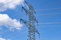 High voltages lines with a big power pylon against the blue  sky Royalty Free Stock Photo