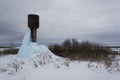 High water tower with a large block of blue ice Royalty Free Stock Photo