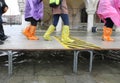 high water in Venice in Italy and people walking over the walkways with waterproof gaiters on feet Royalty Free Stock Photo