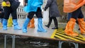 high water in Venice in Italy and people walking over the walkways in waterproof gaiters Royalty Free Stock Photo