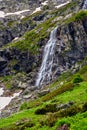 High waterfall and green hill in the mountains Royalty Free Stock Photo