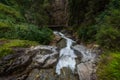 high waterfall while hiking in a gorge over bridges