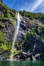 High waterfall in Milford Sound, New Zealand, picture taken from cruise ferry Royalty Free Stock Photo