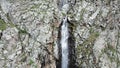 High waterfall among the rocks. View from a drone. Royalty Free Stock Photo