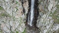 High waterfall among the rocks. View from a drone. Royalty Free Stock Photo