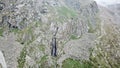 High waterfall among the rocks. View from a drone. Royalty Free Stock Photo