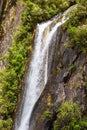 A high waterfall on the way to Franz Josef Glacier. South Island, New Zealand Royalty Free Stock Photo