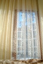 high window with curtain, illuminated by sunlight, selective focus