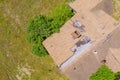 High winds and strong storms have damaged roof shingles from an aerial point of view