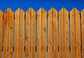 High wooden fence painted brown deck pattern