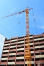 High yellow crane and brick residential building Royalty Free Stock Photo