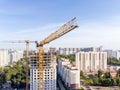 high yellow tower crane near multistorey apartment building under construction. aerial photo Royalty Free Stock Photo