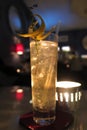 Highball cocktail with lemon twist and thyme