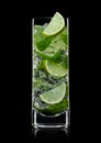 Highball glass of Mojito summer alcoholic cocktail with ice cubes mint and lime on black Royalty Free Stock Photo