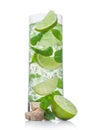 Highball glass of Mojito summer alcoholic cocktail with ice cubes mint and lime on white with cane sugar and raw lime Royalty Free Stock Photo