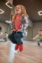 Higher and higher. Portrait of happy cute girl in casual clothes jumping in the studio. Choreography class Royalty Free Stock Photo