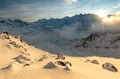 Highest peaks in Wallis Alps with stunning sunset above clouds in winter, Weissmies, Switzerland, Europe Royalty Free Stock Photo