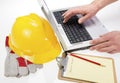 Construction Plans on Laptop with Hardhat Royalty Free Stock Photo