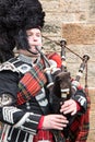 A highland Bagpiper performing in Edinburgh Square