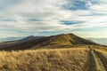 Highland mountain ridge dirt trail travel touristic way early spring time nature landscape scenic view in moody weather time Royalty Free Stock Photo