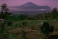 A highlands farmer carying carrying grass with beauty mountain landscape