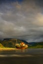 Highlands of Scotland landscape ,abandoned fisherman boat and Ben Nevis at sunset
