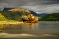 Highlands of Scotland landscape ,abandoned fisherman boat and Ben Nevis at sunset