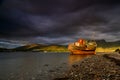 Highlands of Scotland landscape ,abandoned fisherman boat and Ben Nevis at sunset Royalty Free Stock Photo