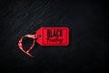 Explosive Red Tag Black Friday Deals on Textured Black Background