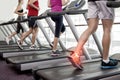 Highlighted ankle of man on treadmill Royalty Free Stock Photo
