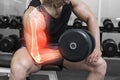 Highlighted arm of strong man lifting weights Royalty Free Stock Photo