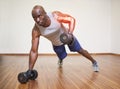 Highlighted arm of strong man lifting weights Royalty Free Stock Photo