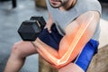 Highlighted arm of strong man lifting weights at gym Royalty Free Stock Photo