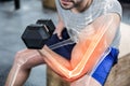 Highlighted arm of strong man lifting weights at gym Royalty Free Stock Photo