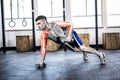 Highlighted body of strong man lifting weights at gym