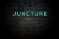 Highlighted brick wall with neon inscription juncture Royalty Free Stock Photo