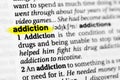 Highlighted English word `addiction` and its definition in the dictionary Royalty Free Stock Photo