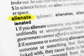 Highlighted English word `alienate` and its definition in the dictionary Royalty Free Stock Photo