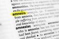 Highlighted English word `amnesia` and its definition in the dictionary