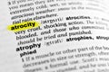 Highlighted English word `atrocity` and its definition in the dictionary