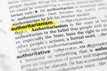 Highlighted English word `authoritarianism` and its definition in the dictionary