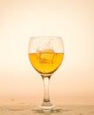 Highlighted in orange glass with white wine and ice. Royalty Free Stock Photo