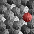 Highlighted red umbrella among multiple black and white umbrellas forming a beautiful texture pattern background