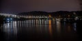 Lights reflect in the water at night