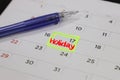 highlighter with a circled holiday day on calendar Royalty Free Stock Photo