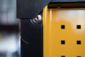 Close-up view of a secure locking mechanism on a vibrant yellow storage unit